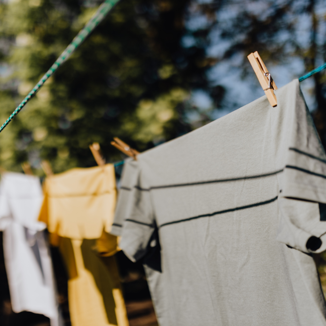 Clothes hanging on a clothing line outdoors drying in the sun.